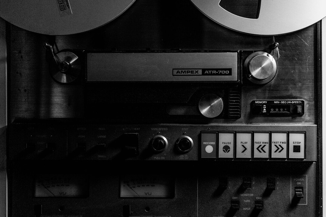 Archival-style vintage home recording studio with analog mixing console and reel-to-reel tape